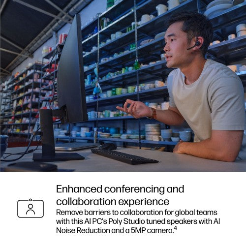 Silver HP ProBook 16-inch laptop open on desk with person wearing headset using it in workshop setting.