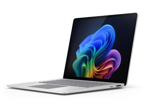 Silver Microsoft Surface Laptop 7 with black keyboard and colorful abstract screen background.