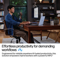 Silver HP EliteBook 14-inch laptop open on a wooden desk with touchscreen displaying software, man sitting and using mouse.