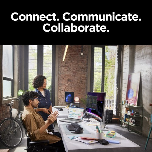 HP ZBook Power G11 laptop with 16-inch screen on desk in industrial-style office with two people collaborating.