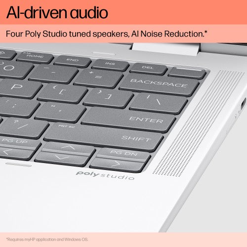 Silver HP Elite x360 laptop corner showing black keyboard keys and right-side speaker grille with Poly Studio branding.
