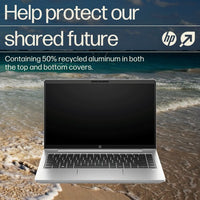 Silver HP ProBook 440 G10 laptop open on sandy beach with black keyboard and screen off.