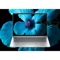 HP EliteBook 14-inch laptop with silver chassis, black keyboard, and vibrant blue flower wallpaper on screen.