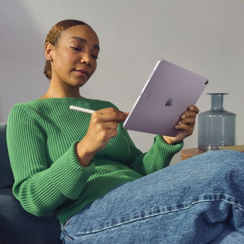 Person using blue Apple iPad Air 6th Gen with Apple Pencil and slim bezels.