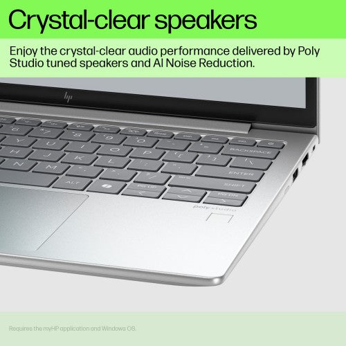 Silver HP EliteBook laptop keyboard and palm rest with visible speaker grills near hinge and screen edge text about.