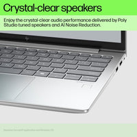 Silver HP EliteBook laptop keyboard and palm rest with visible speaker grills near hinge and screen edge text about.